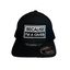 Front product shot of black cap with embroidered text and visible Unipanel Flexfit stickers on visor